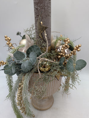 Nahaufnahme des Gestecks: Holzstern an der Kerze, Kugeln in Creme, Rosé und Gold zwischen Eukalyptus und Kiefernzweigen