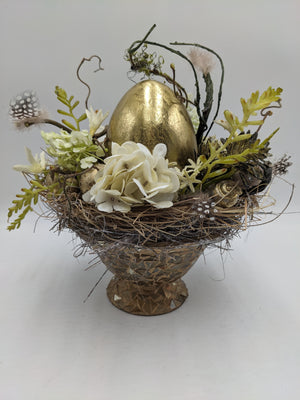 Ostergesteck mit großem goldenem Ei, cremeweißer Hortensie, Hyazinthen und Federn in Mosaik-Fußschale
