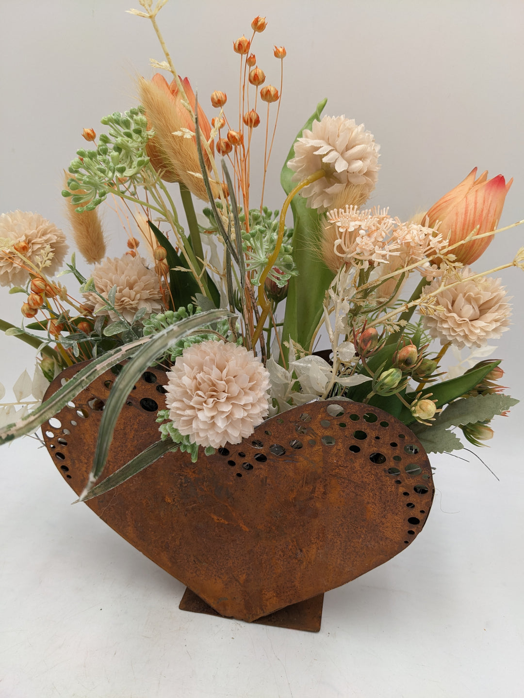 Frühlingsgesteck Herz Tulpen Gräser apricote