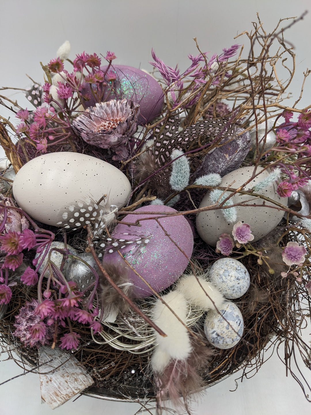 Ostergesteck Frühlingsgesteck Nest Federn Kätzchen lila