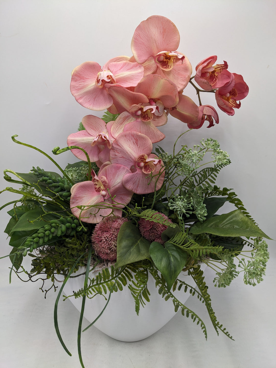 Frühlingsgesteck Orchideen Sedum rosa