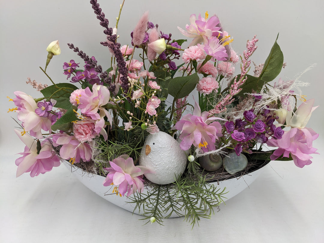 Frühlingsgesteck Vogel Gräser rosa lila