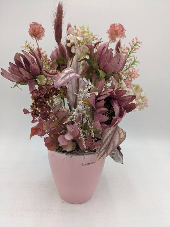 Herbstgesteck Sonnenblumen Gräser rosa