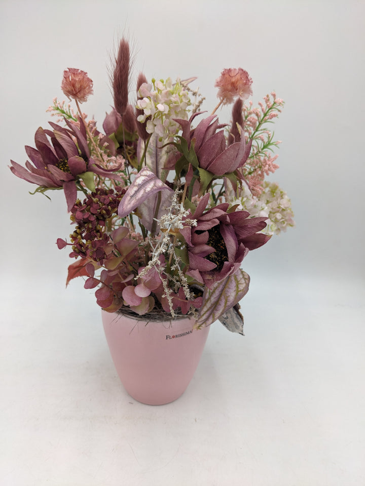 Herbstgesteck Sonnenblumen Gräser rosa