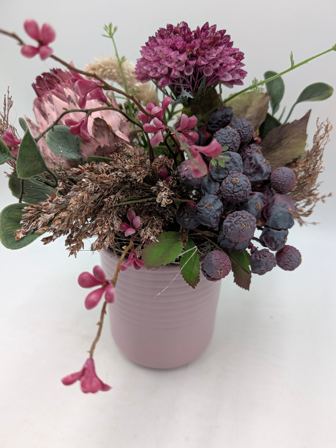 Frühlingsgesteck Artischocke Gräser lila rosa