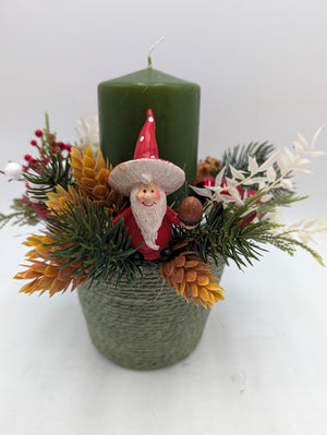 Weihnachtsgesteck von vorn: Wichtel mit roter Mütze zwischen Tannenzweigen, Hopfen und weißen Blattzweigen