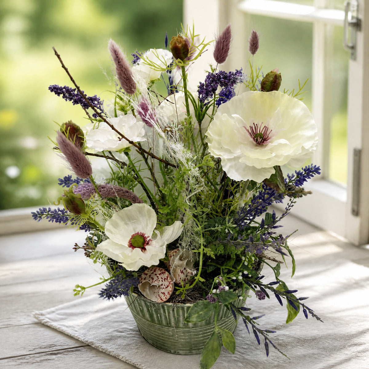 Szene Sommergesteck Lavendel Gräser Mohn Muscheln lila weiss