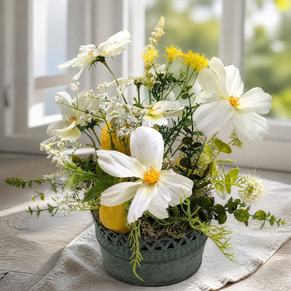 Szene Sommergesteck Zitronen Blüten Gräser weiss gelb