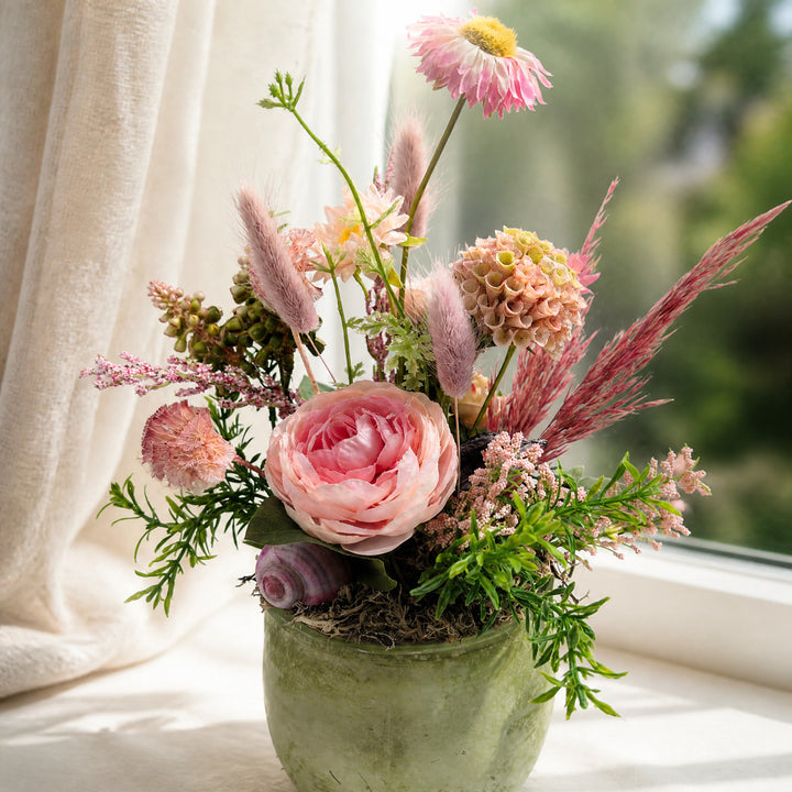 Szene Frühlingsgesteck Ranunkel Gräser Schnecke rosa grün