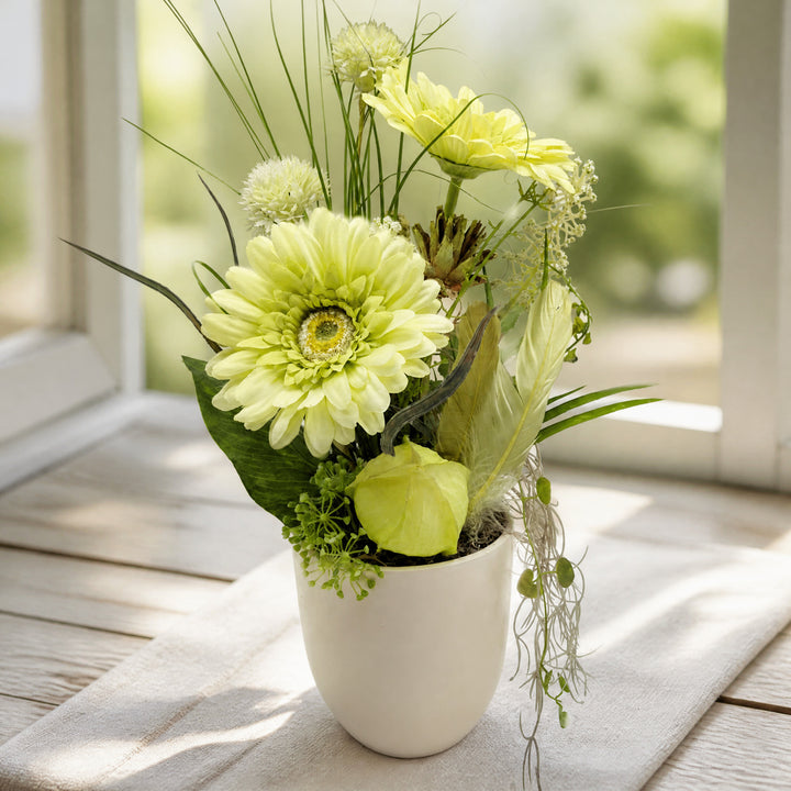Szene Sommergesteck Tischgesteck Gerbera Physalis Federn Gräser grün creme