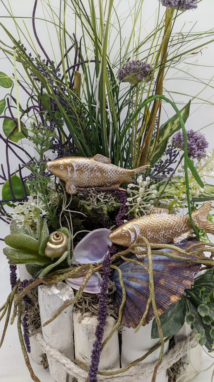Tischgesteck Sommergesteck Maritim Fische Schnecken Muscheln Blüten Gräser lila gold