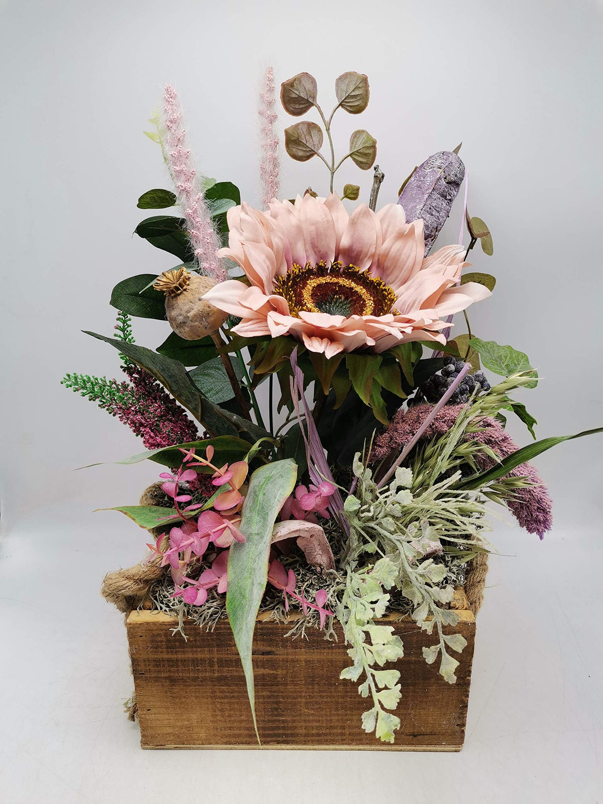 Herbstgesteck im Holzkasten mit rosa Sonnenblume, Mohnkapsel, Heide und hohen rosa Gräsern